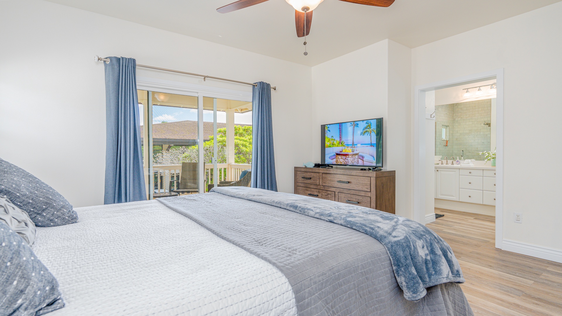 Kapolei Vacation Rentals, Coconut Plantation 1078-1 - A lanai access  from the primary bedroom and a TV, perfect for movie nights.