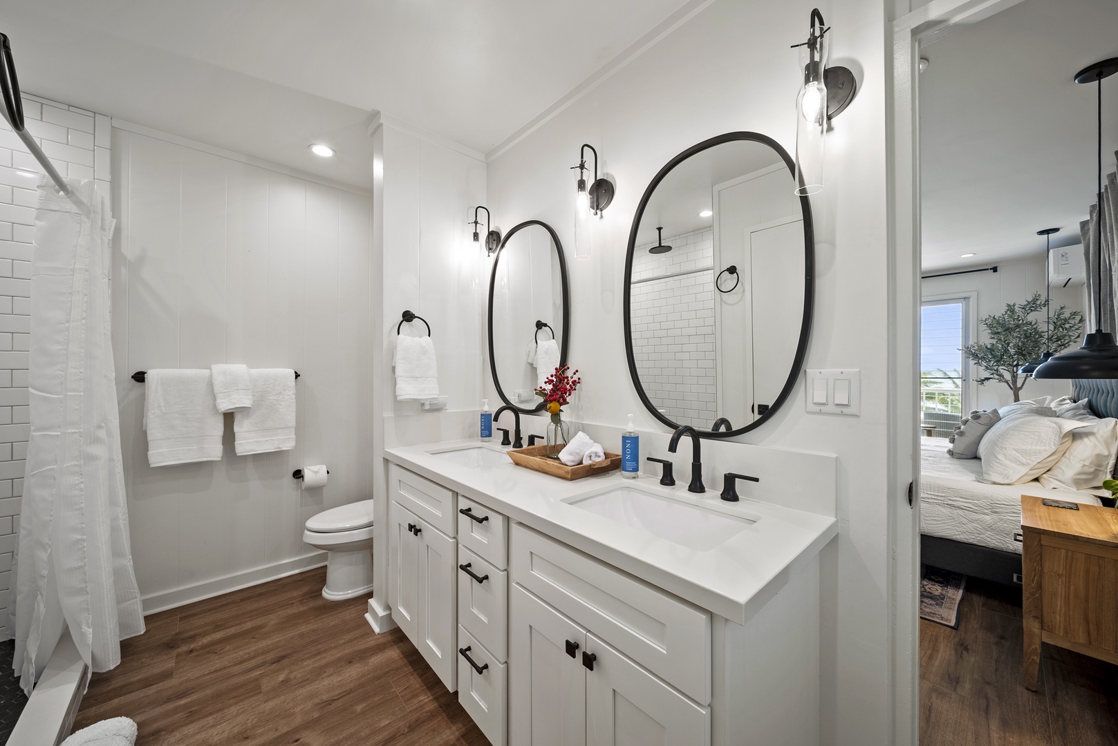 Honolulu Vacation Rentals, Honolulu Beachfront Retreat - The ensuite has double vanity bathroom with round mirrors, modern lighting, and a spa-inspired design perfect for unwinding.