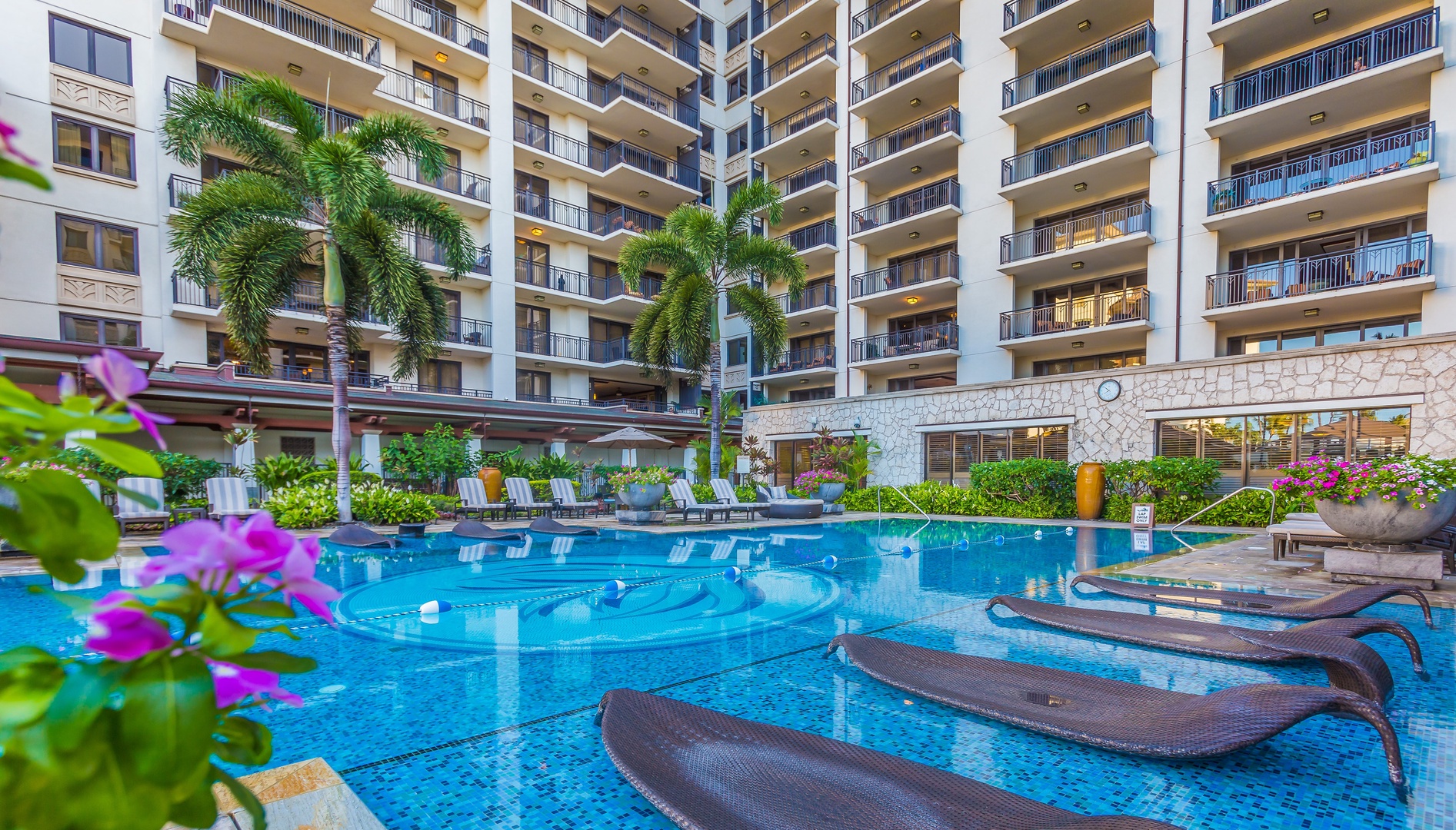 Kapolei Vacation Rentals, Ko Olina Beach Villas O1006 - Water loungers at the lap pool with beautiful surroundings.