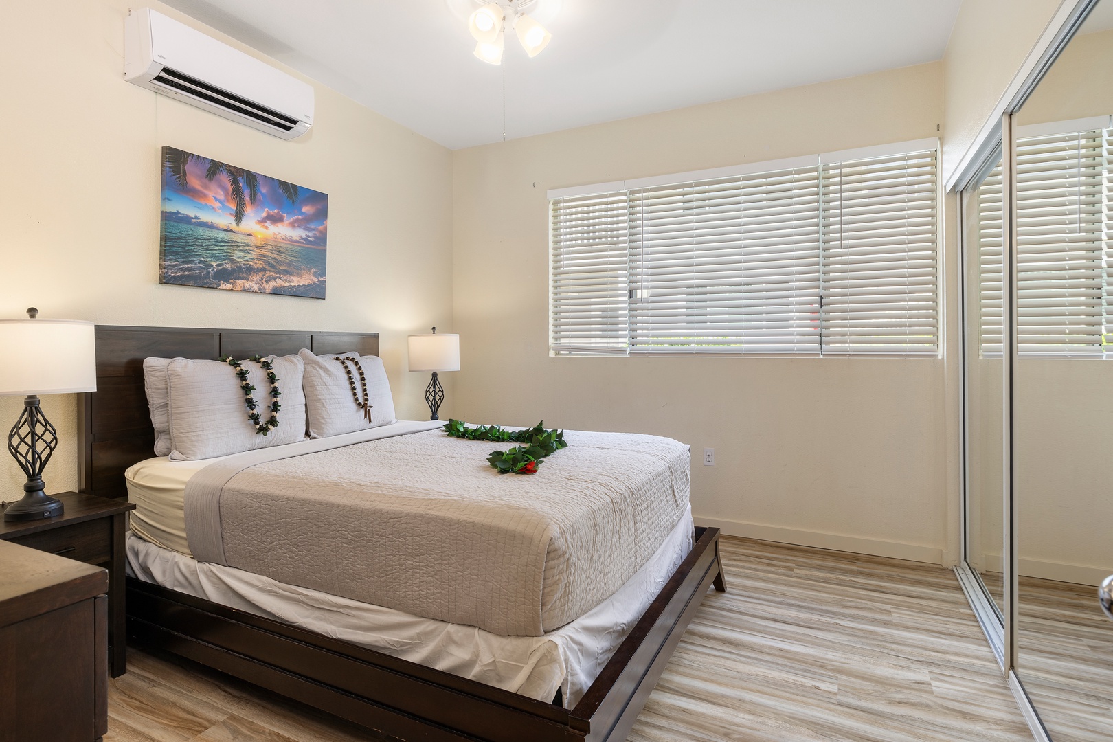 Drift off to sleep in your tranquil bedroom, where tropical artwork and fresh flowers create an island-inspired retreat with modern comfort.