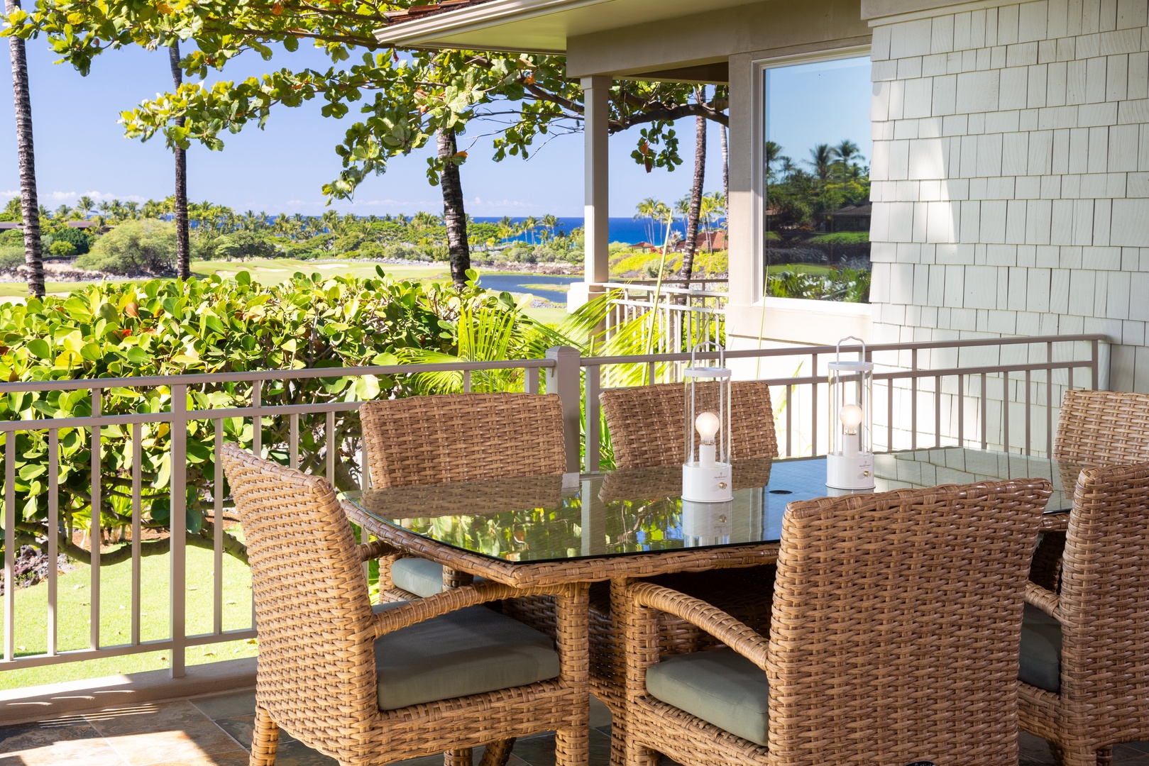 Kailua Kona Vacation Rentals, 3BD Waiulu Villa (111D) at Hualalai Resort - Lanai with a table for six, perfect for alfresco dining amidst lush tropical surroundings.