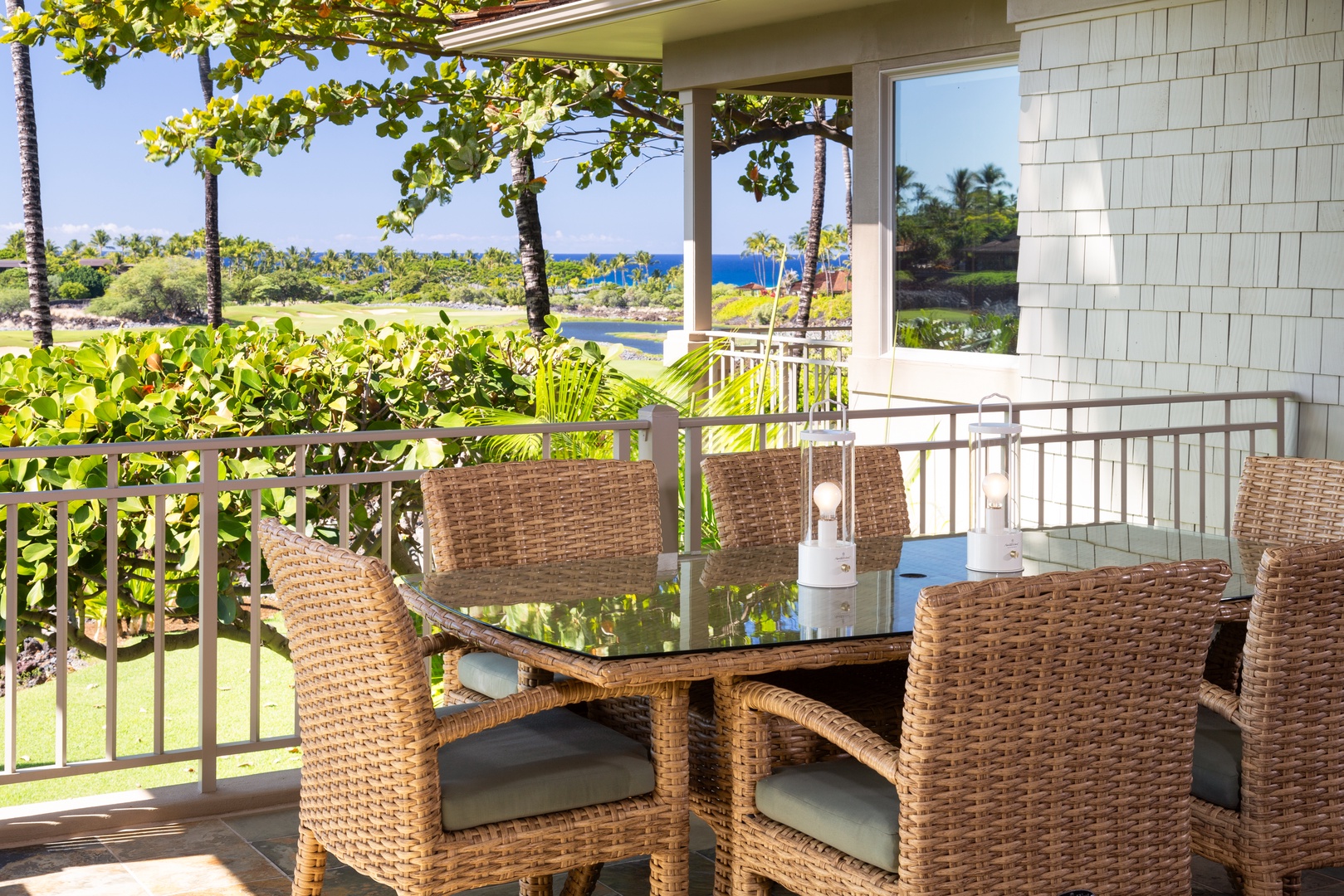 Kailua Kona Vacation Rentals, 3BD Waiulu Villa 111D at Hualalai Resort - Lanai with a table for six, perfect for alfresco dining amidst lush tropical surroundings.