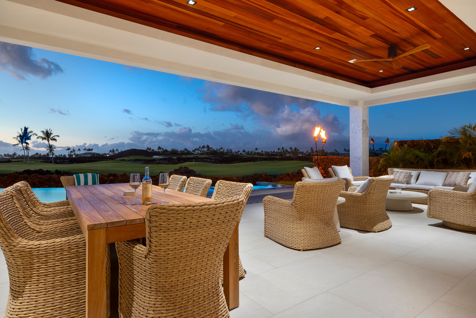 Kamuela Vacation Rentals, 6BD Mauna Lani Lux Golf Estate (5) at One Ocean - Evening settles over the deck, the pool lit and the chairs still out.