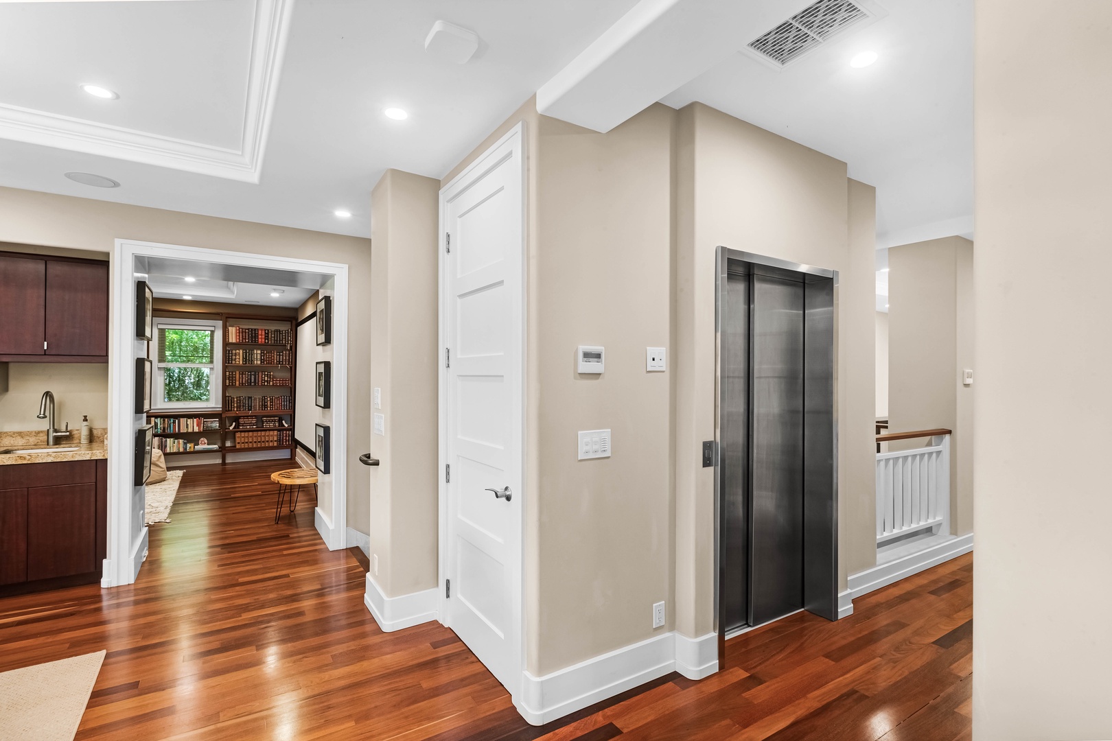 Honolulu Vacation Rentals, Pili Pono - Spacious hallway with private elevator and hardwood flooring.