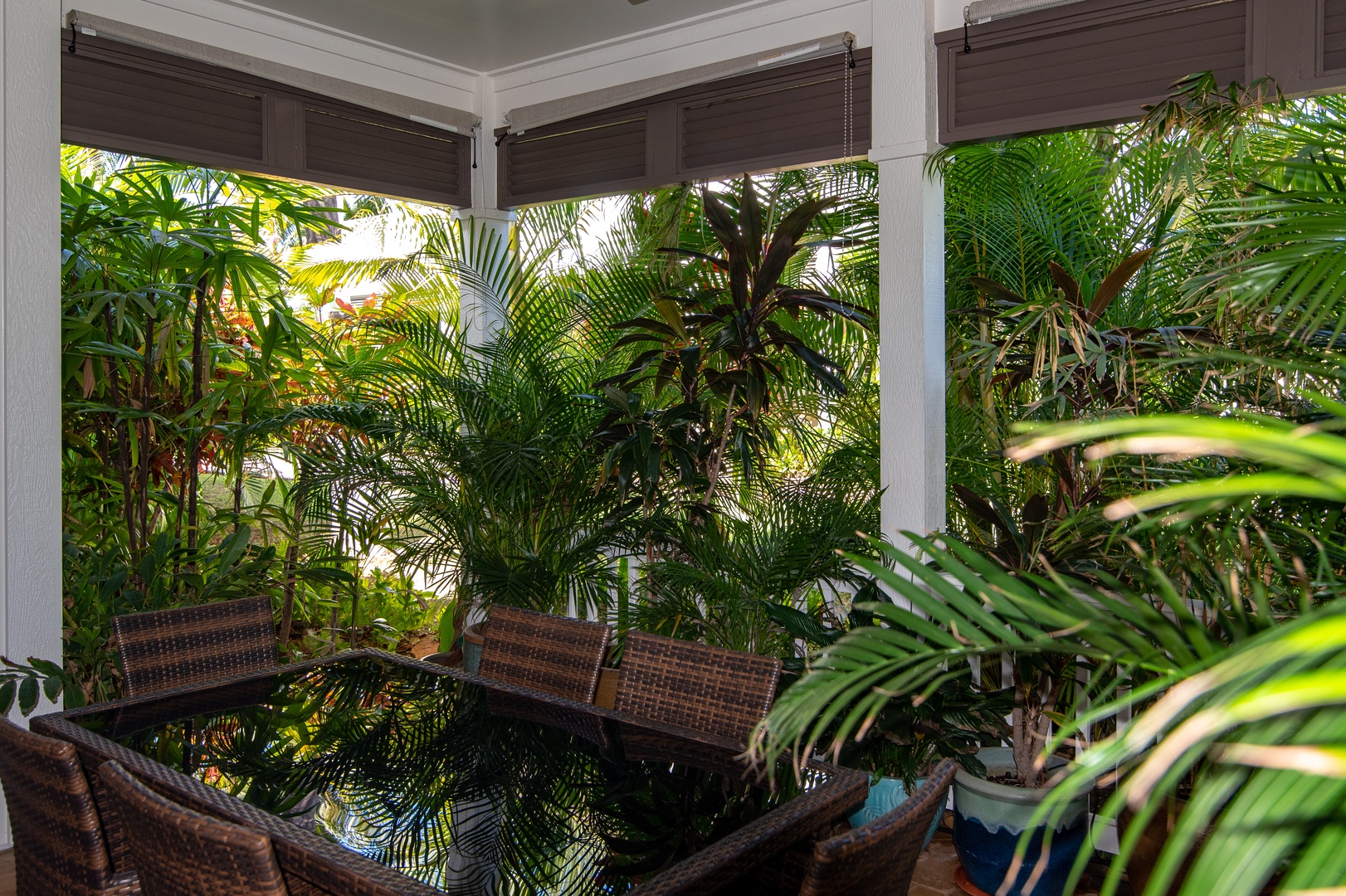 Kapolei Vacation Rentals, Coconut Plantation 1200-4 - The lanai provides a dining space surrounded by tropical plants.
