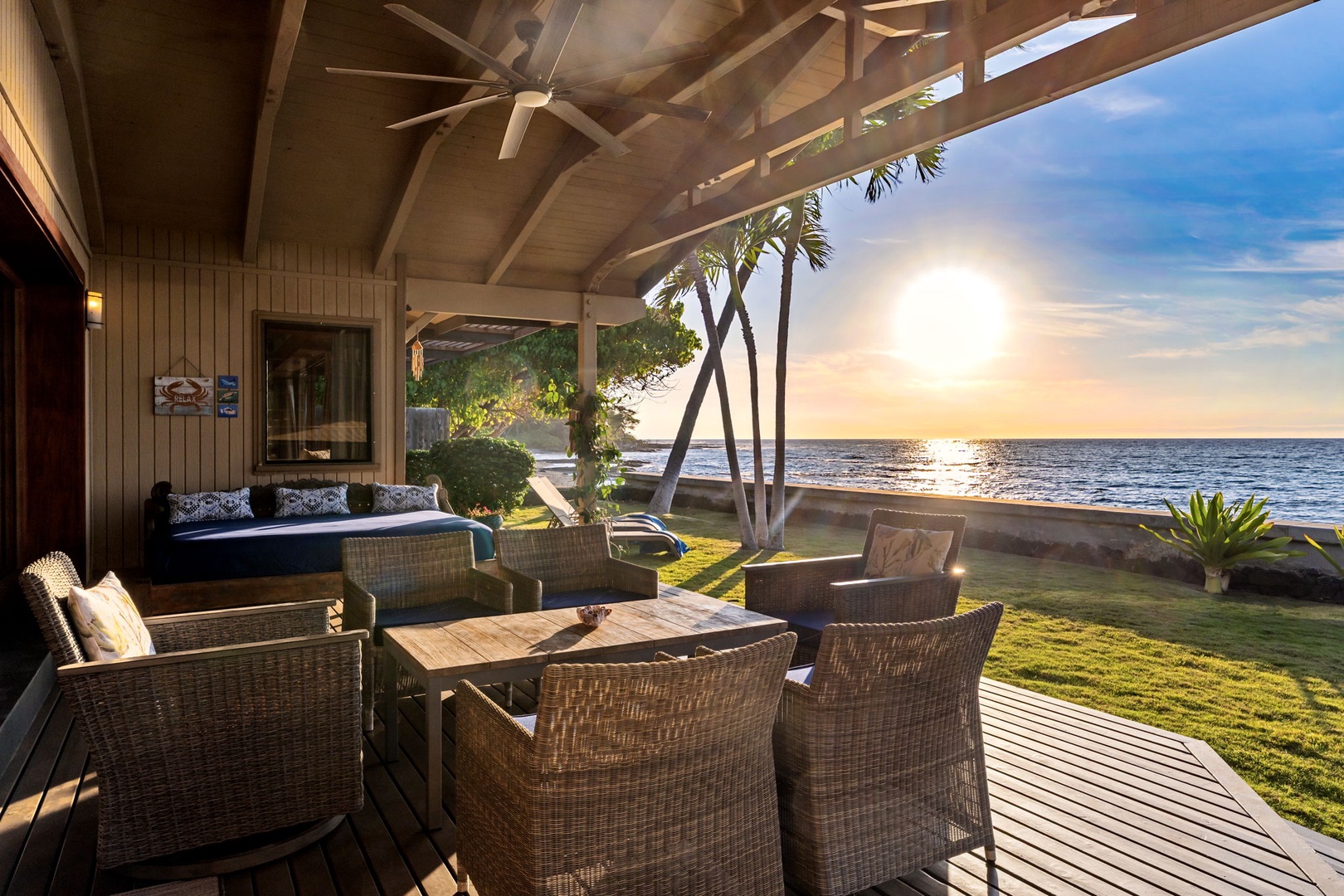 Kamuela Vacation Rentals, Island Time Retreat - Lanai seating under the roofline, angled at the water for golden hour.