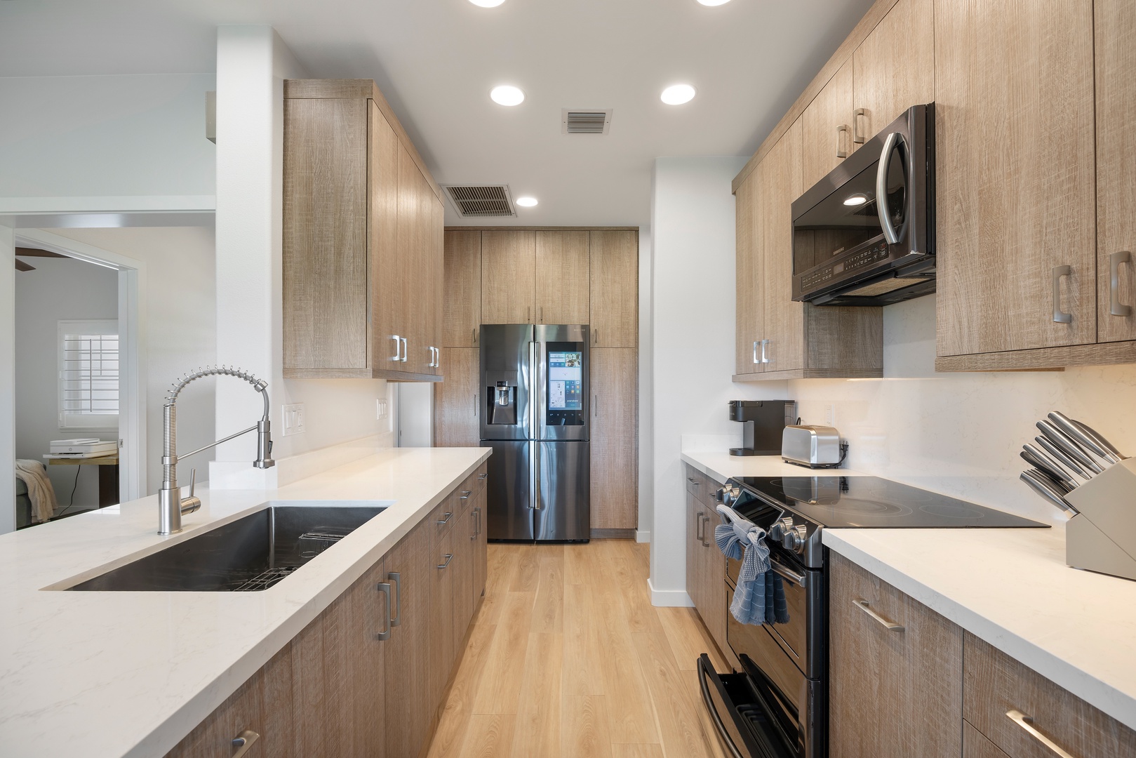 Cook your favorite meals in this modern galley kitchen with quartz counters, stainless appliances, and everything you need for your stay.