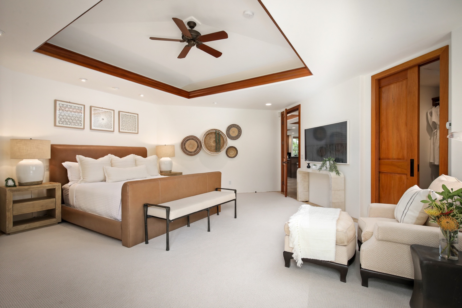 Kailua Kona Vacation Rentals, 4BD Pakui Street Estate (147) at Hualalai Resort - Luxurious primary bedroom suite w/king bed, television, seating area, outdoor access and en suite bath.