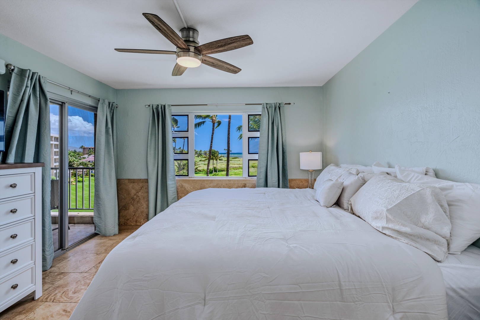 Kihei Vacation Rentals, Menehune Shores 420 - The primary suite opens to the lanai, with the water just past the rail.