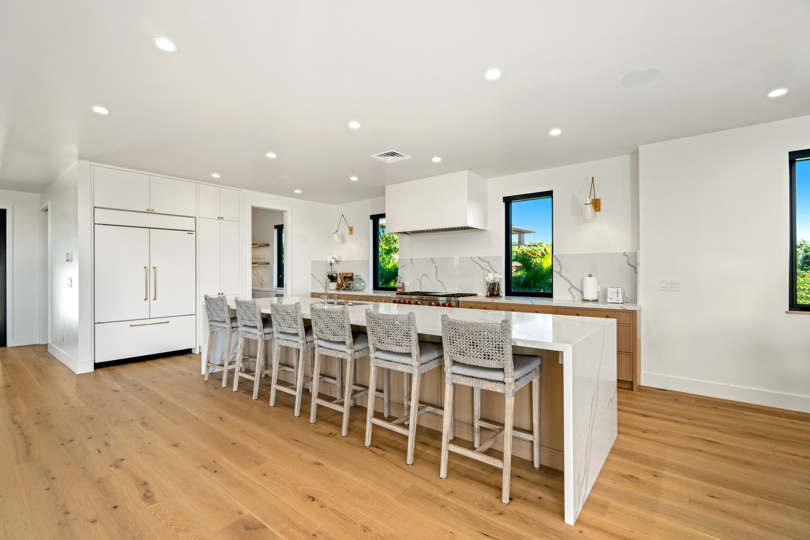 Koloa Vacation Rentals, Hale Laule'a at Kukui'ula - Gather with friends at your spacious kitchen island, where modern elegance meets comfort in this bright, open kitchen.