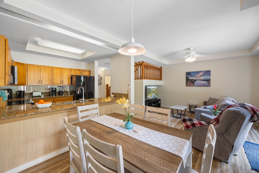 Gather around your spacious open-concept kitchen and dining area, where warm wood tones and granite counters create the perfect space for memorable meals.