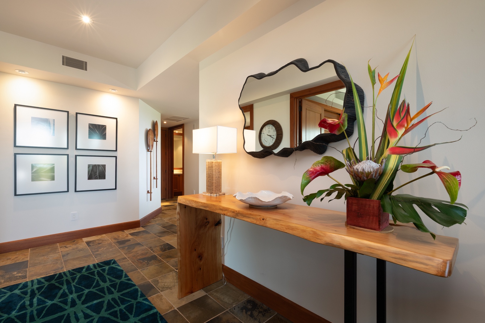 Kailua Kona Vacation Rentals, 3BD Waiulu Villa (111D) at Hualalai Resort - Step into your stylish entryway where tropical blooms and warm wood accents create an inviting first impression.
