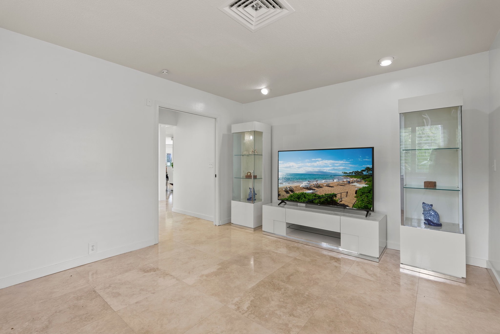 Honolulu Vacation Rentals, Paradise Beach Estate - Kick back in the media lounge, where a wall-mounted TV and soft lighting create the perfect hub for movie nights or downtime.