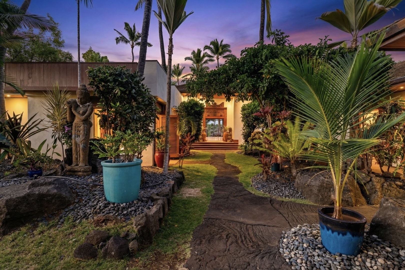 Kailua-Kona Vacation Rentals, Hahalua Bay Villa - Hahalua Bay Villa entrance features lush landscaping and warm island architecture beneath a stunning twilight sky.
