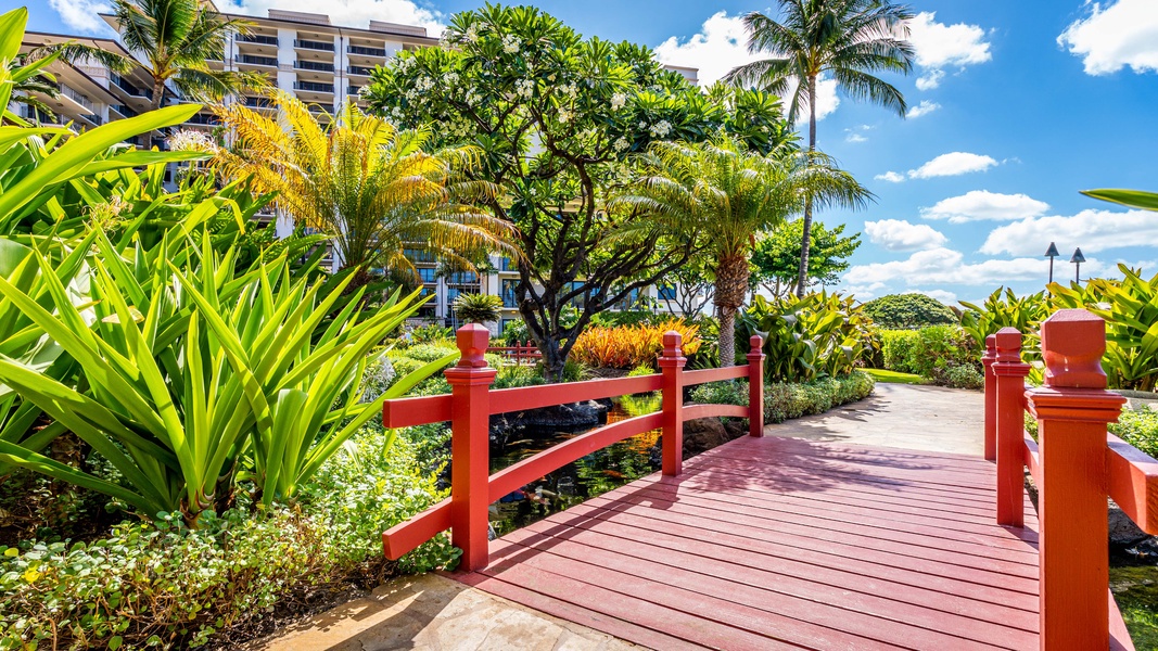 Kapolei Vacation Rentals, Ko Olina Beach Villas B210 - Garden walkway with koi pond and lush greenery.