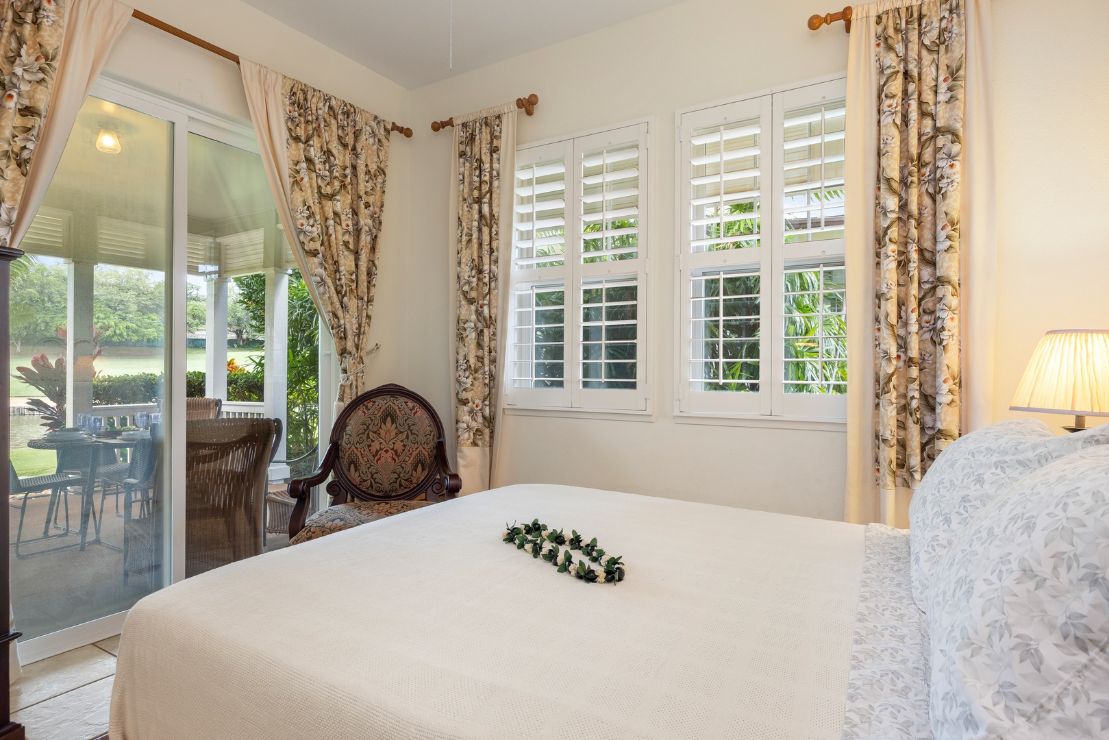 Kapolei Vacation Rentals, Coconut Plantation 1150-2 - Your bedroom retreat with garden views, where elegant florals and soft lighting create the perfect sanctuary for restful nights.