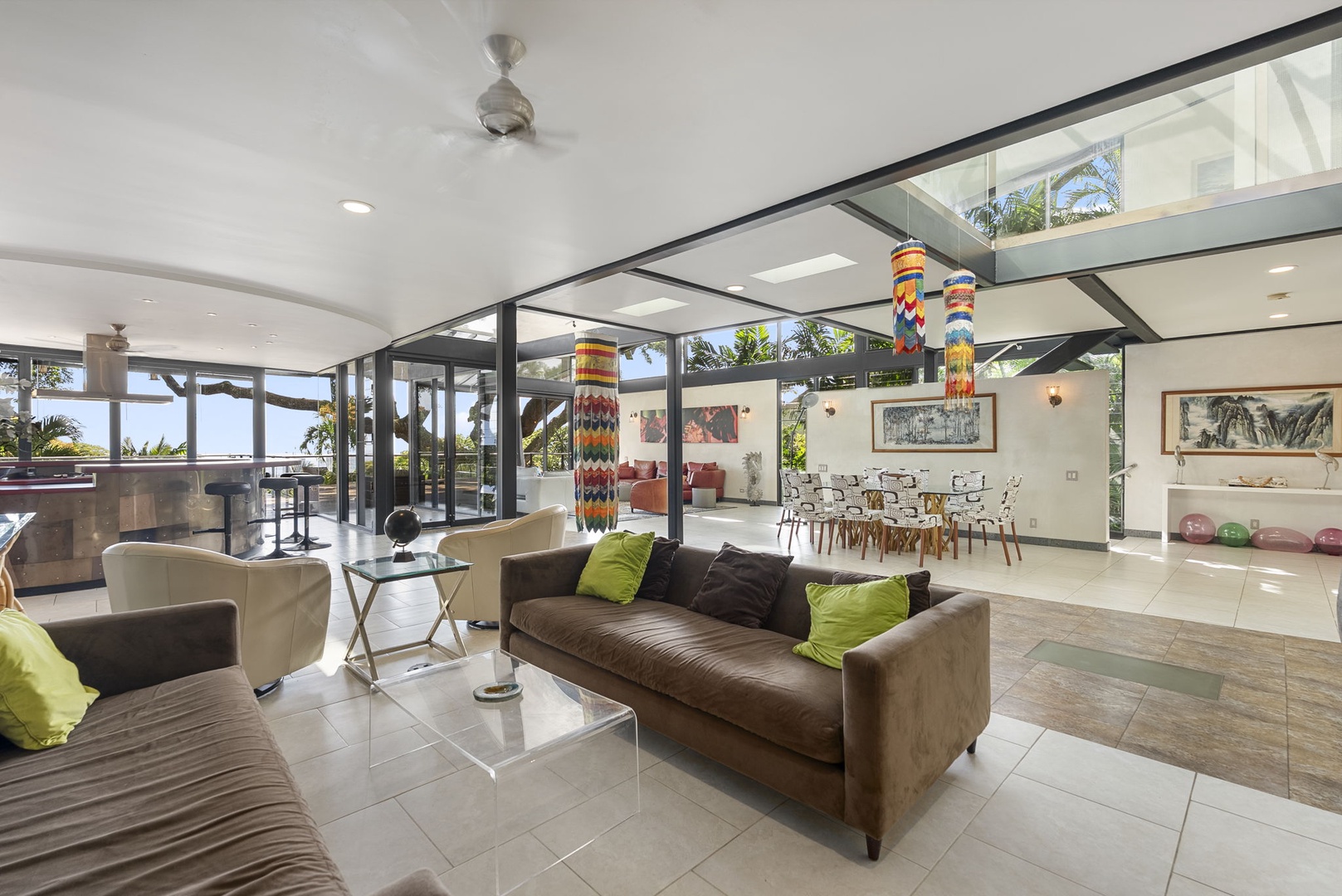 Honolulu Vacation Rentals, Tantalus Glass House (3 BD) - Relax in your open-plan living space with sleek furnishings, soaring ceilings, and floor-to-ceiling windows showcasing tropical palms.