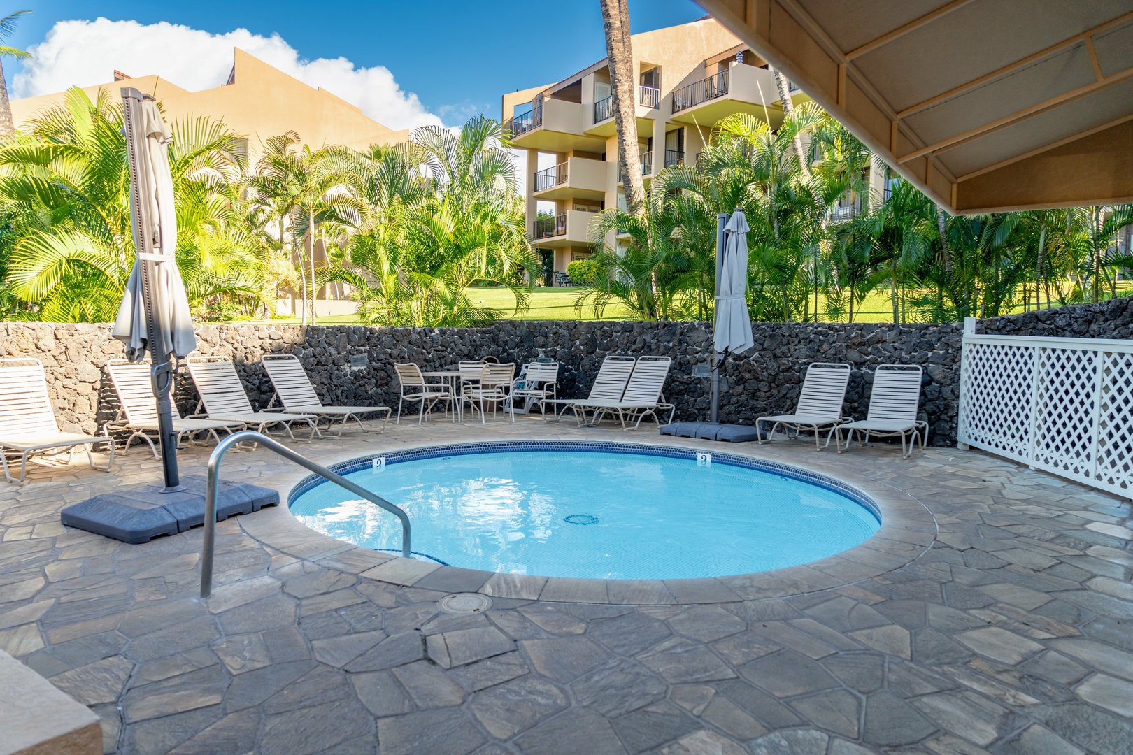 Kihei Vacation Rentals, Kamaole Sands 5310 - Slip into one of the two hot tubs, lounge chairs curved around it for the group.