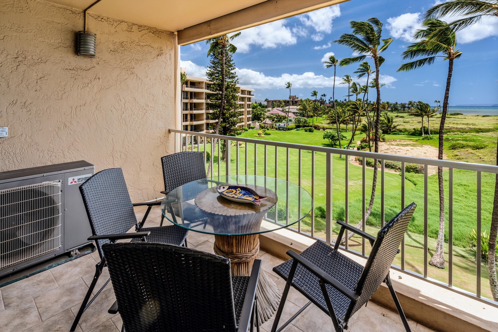 Kihei Vacation Rentals, Menehune Shores 420 - Settle on the lanai over the lawn, palms and water stretching out past the rail.