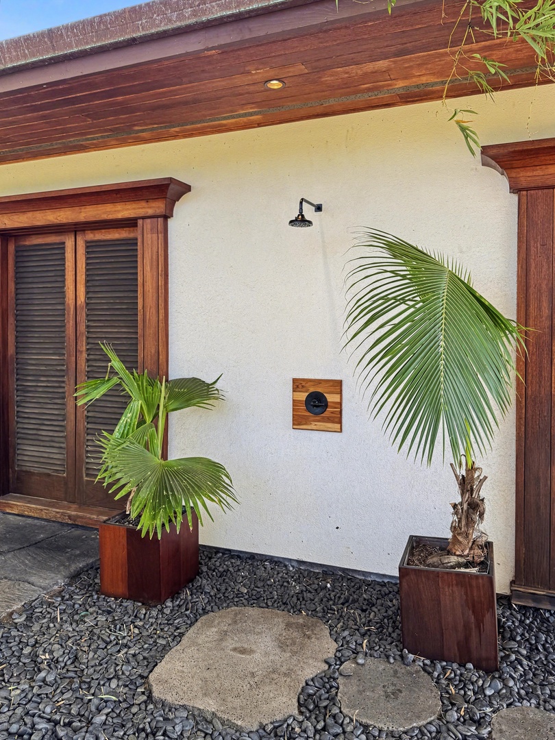 Kailua-Kona Vacation Rentals, Hahalua Bay Villa - Modern tropical property featuring rich wood accents, private outdoor shower area, and lush landscaping for a serene vacation setting.
