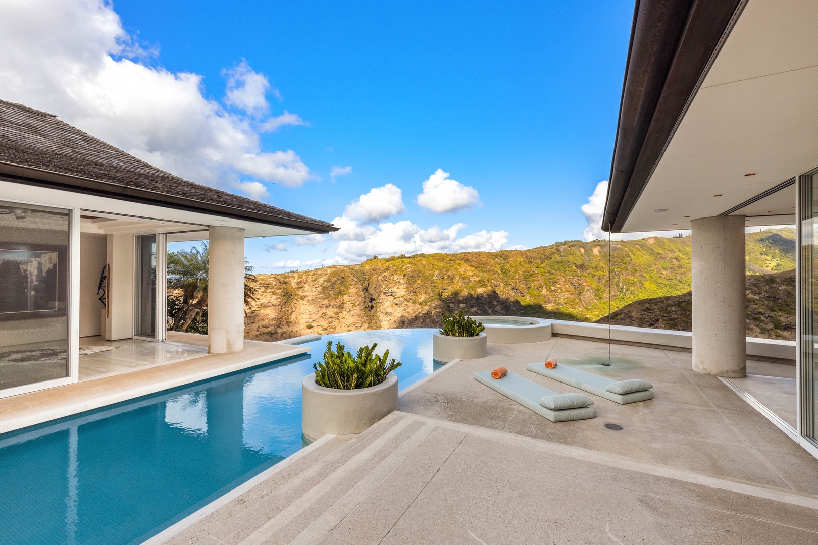 Honolulu Vacation Rentals, Sky Ridge House - Dive into the azure embrace of this infinity pool, where the water's edge seamlessly merges with the stunning mountainous horizon