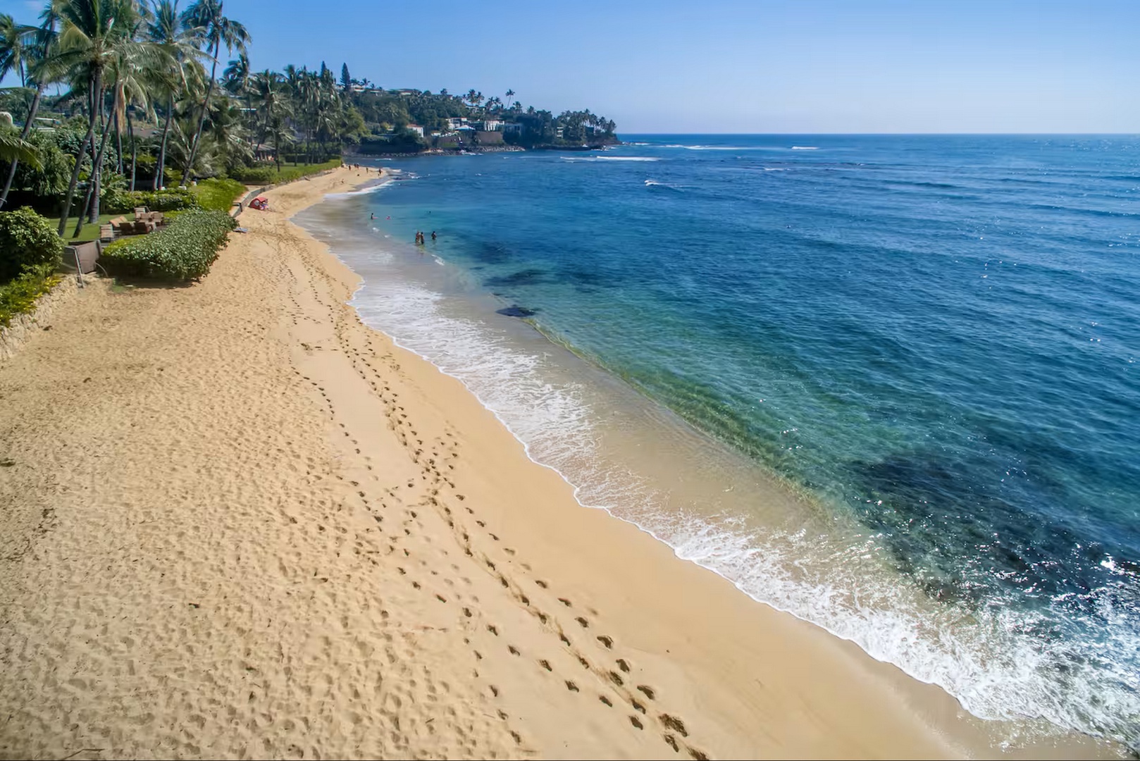 Honolulu Vacation Rentals, Diamond Head Beachfront Estate 9BR - A soft sand beach and turquoise water stretch along the shoreline below.