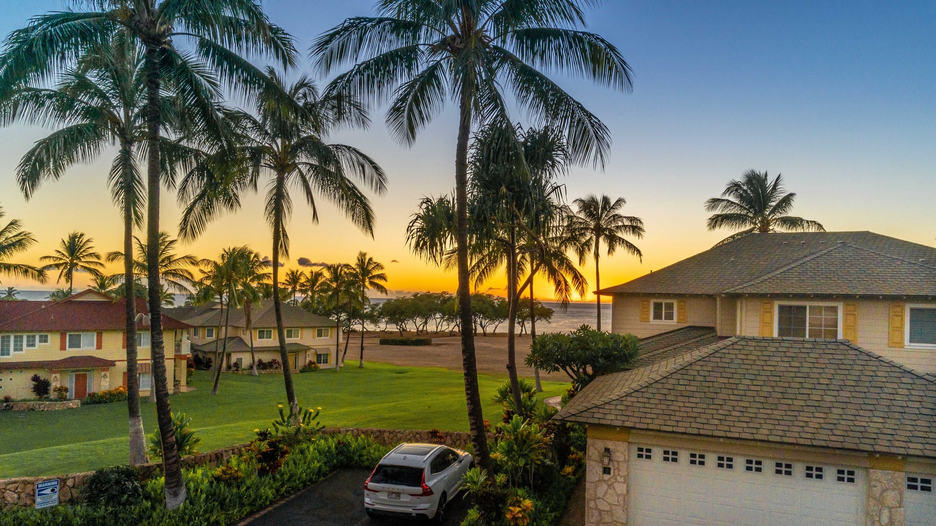 Kapolei Vacation Rentals, Kai Lani 16C - An aerial view over the condo of island sunsets and swaying palm trees.