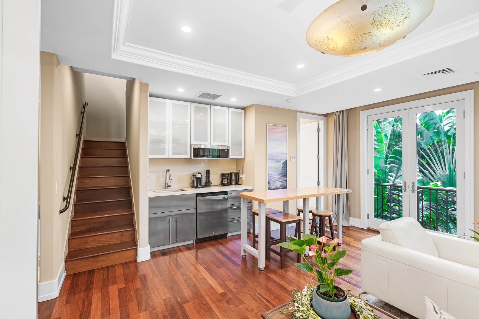 Honolulu Vacation Rentals, Pili Pono - Bright studio kitchen with island seating and sleek modern finishes.