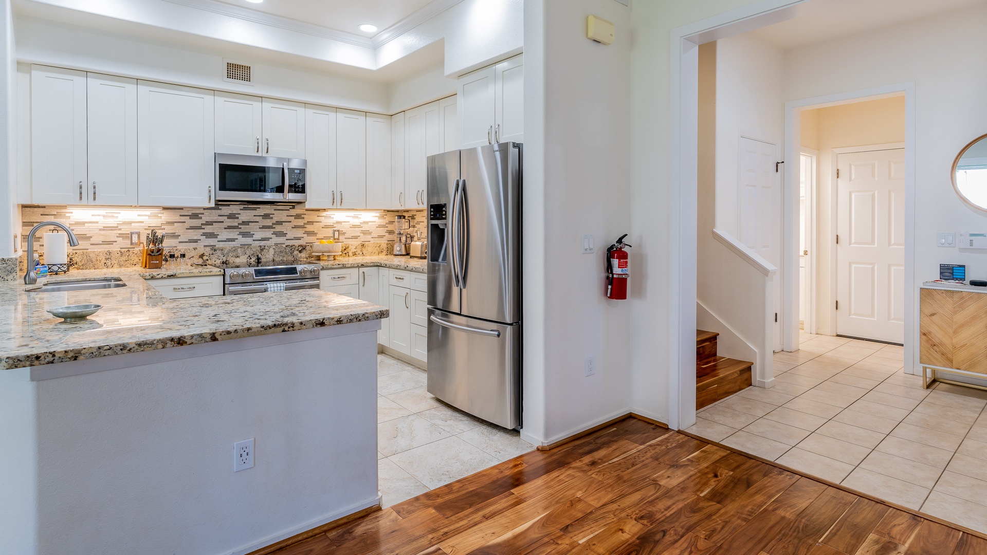 Kapolei Vacation Rentals, Coconut Plantation 1158-1 - A picture of the stairs inside the condo near the kitchen.