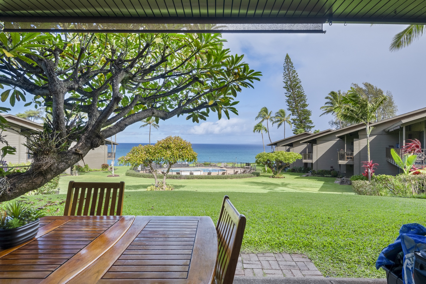 Lahaina Vacation Rentals, Polynesian Shores 114 - Meals move out to the shaded lanai here, with the lawn opening onto the ocean just beyond.