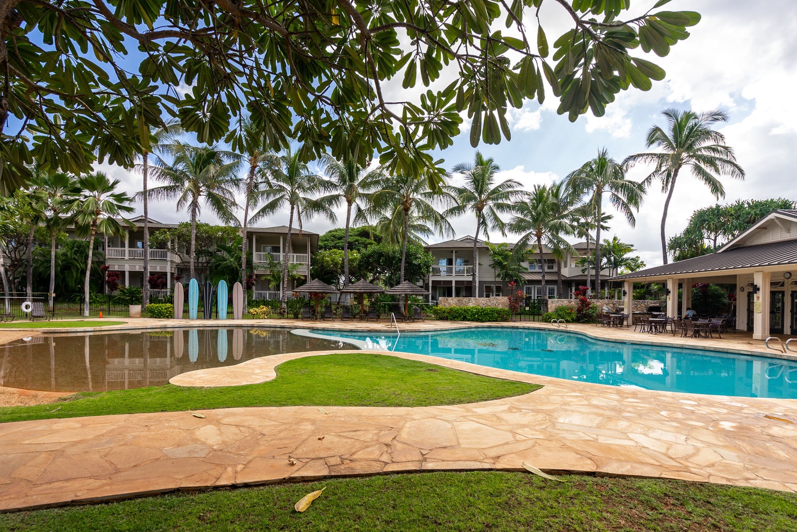 Kapolei Vacation Rentals, Coconut Plantation 1080-4 - The community pool opens up nearby, palms leaning over the deck.