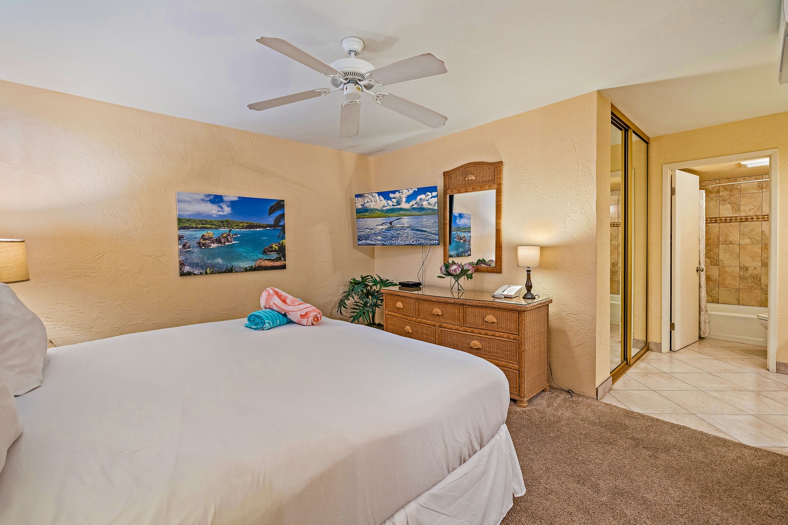 Lahaina Vacation Rentals, Papakea G-306 - The bedroom is designed for comfort, featuring a TV, ample storage, and soft lighting, creating a relaxing space to unwind after a busy day.