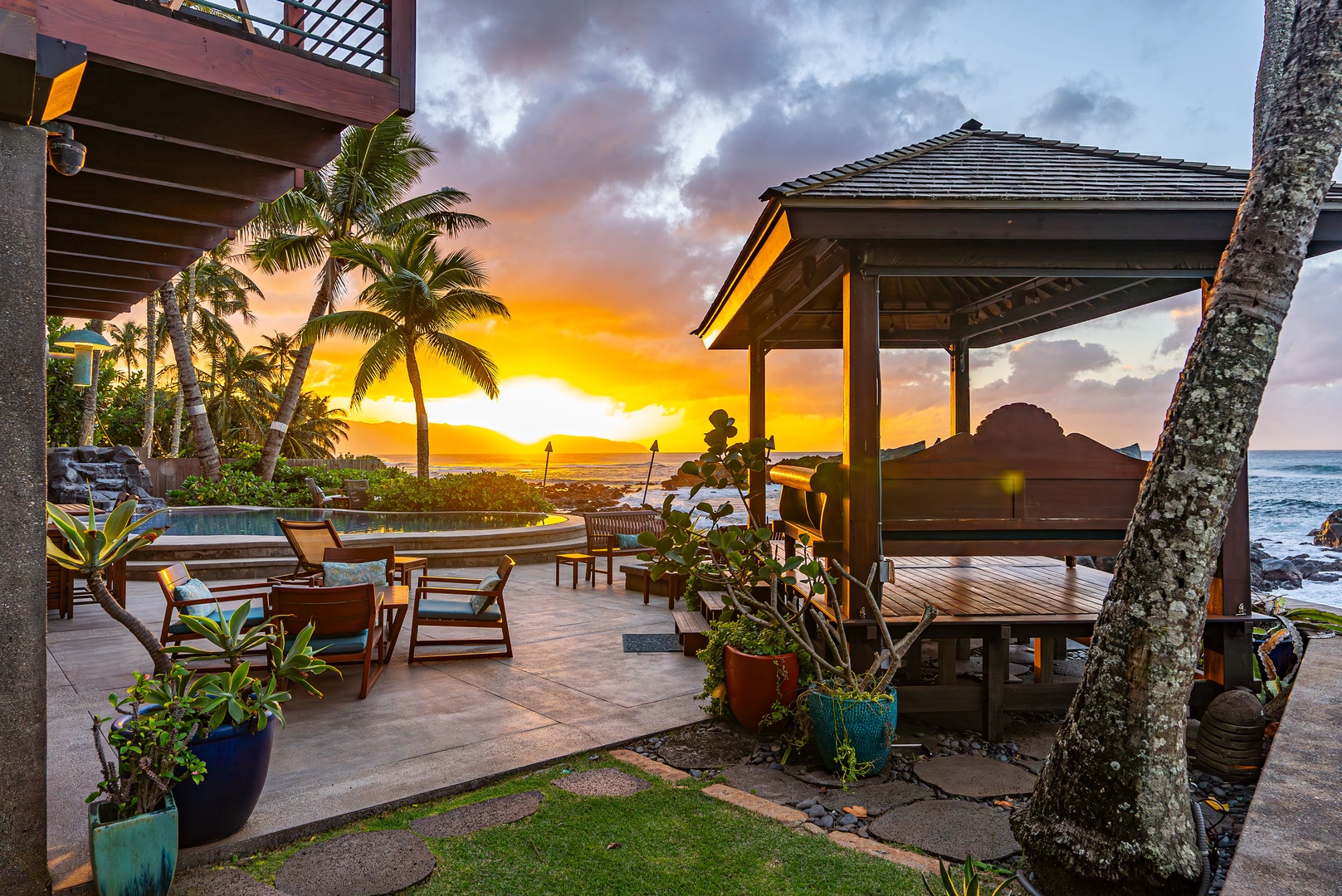 Haleiwa Vacation Rentals, Samurai House - Sunset views from a cozy gazebo surrounded by tropical greenery.