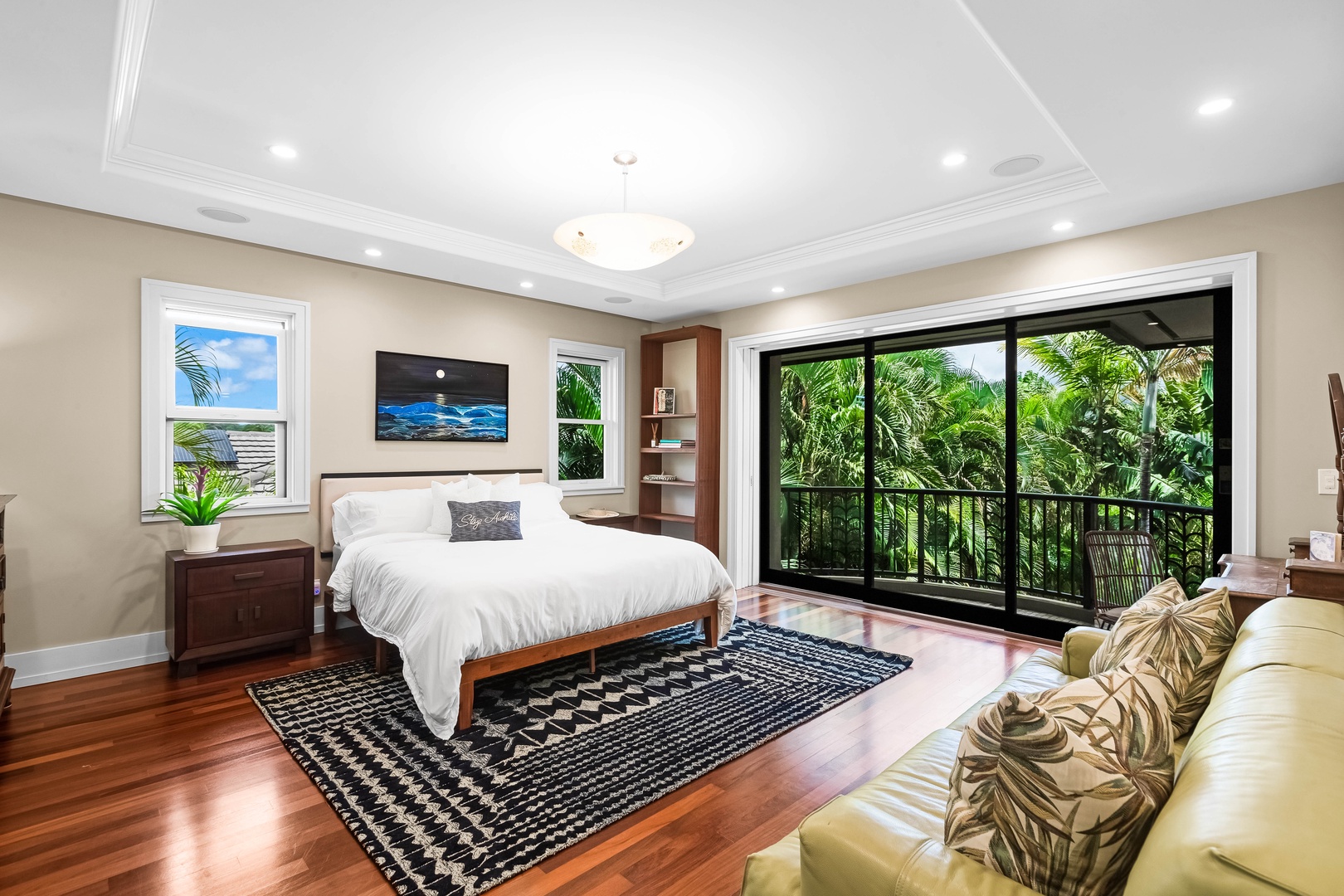 Honolulu Vacation Rentals, Pili Pono - Expansive guest suite with California king bed, and tropical backdrop.
