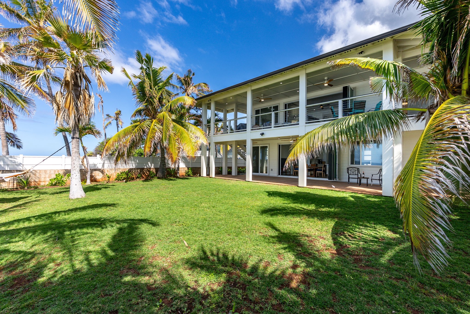 Waianae Vacation Rentals, Oceanfront Luxury Dream Estate - A wide-angle view of the estate exterior shows how seamlessly the indoor and outdoor spaces connect.