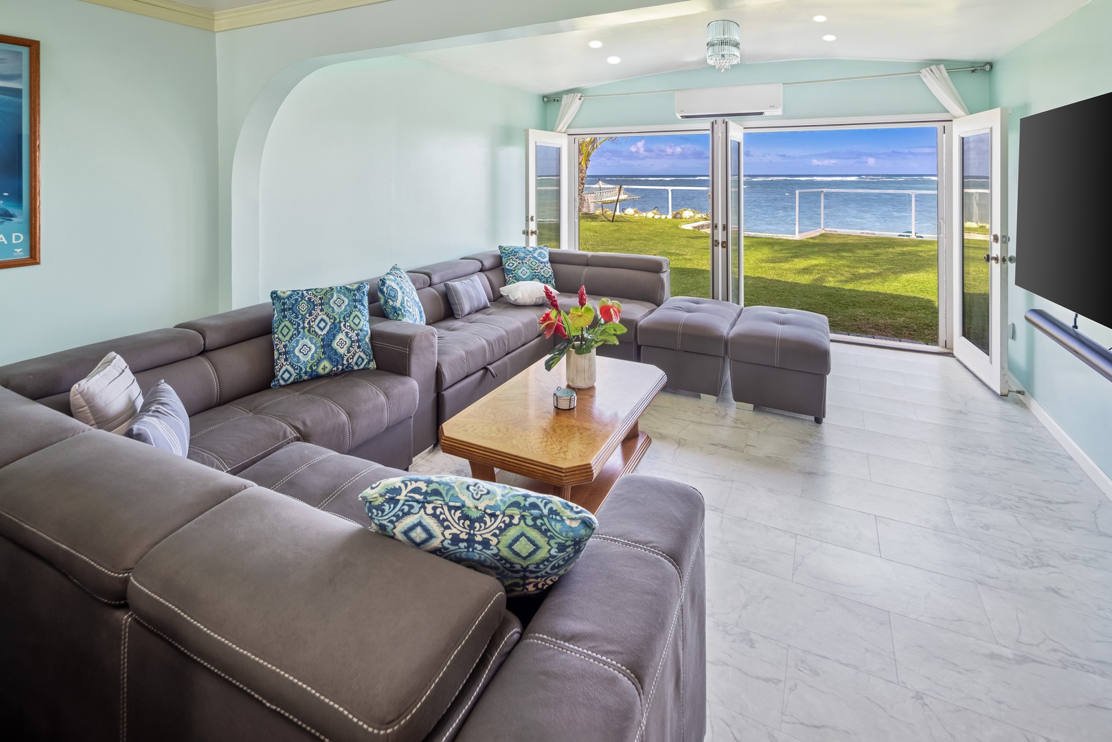 Hauula Vacation Rentals, Private Beach Paradise - A wide sectional, sliding doors thrown open, the lawn and ocean just outside.