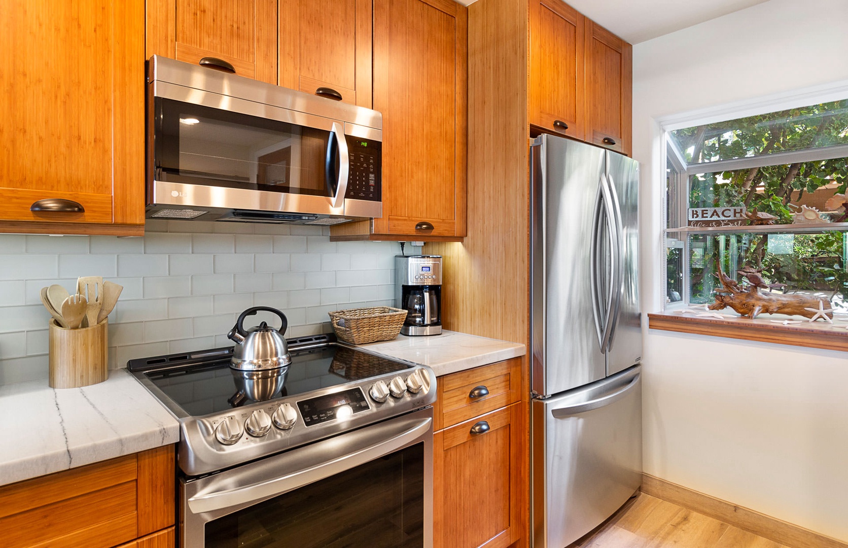 Lahaina Vacation Rentals, Puamana 240-3 - A stunning kitchen featuring stainless steel appliances and a sleek, modern design.