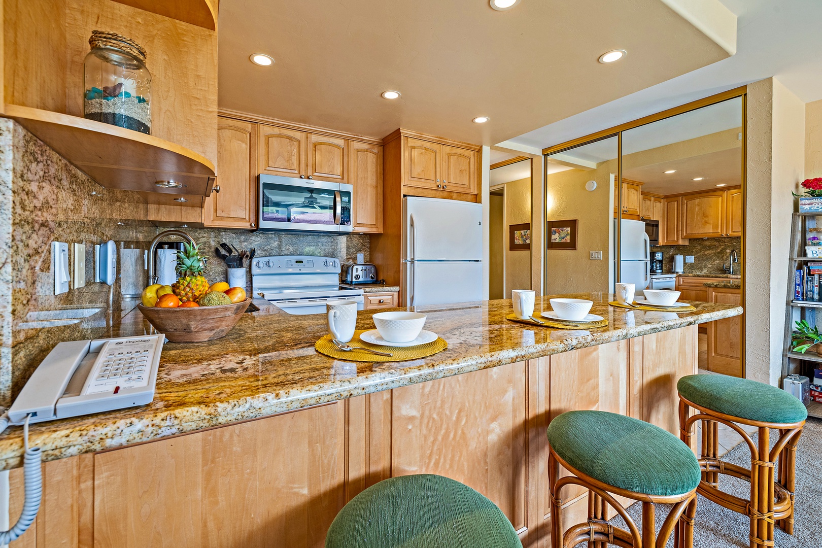 Lahaina Vacation Rentals, Papakea G-306 - The kitchen features a spacious breakfast bar with seating for four, ideal for casual meals or enjoying a quick snack before heading out to explore.