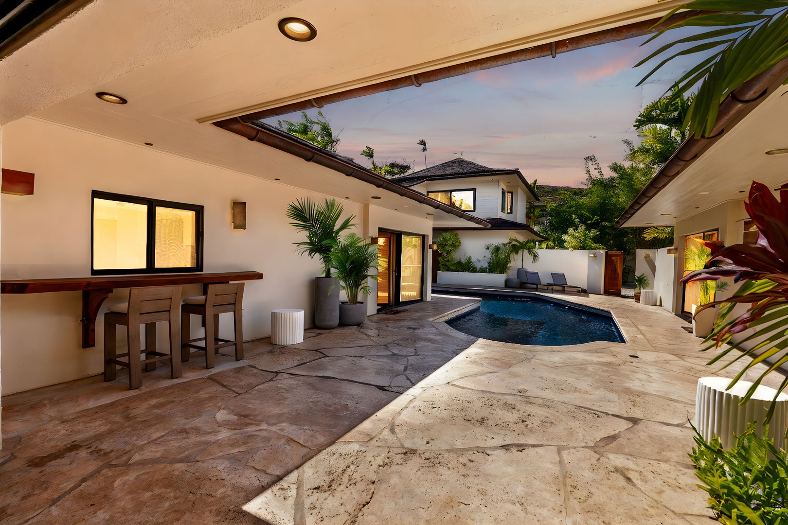 Honolulu Vacation Rentals, Honolulu Lagoonfront Villa - Enjoy sunset cocktails at the poolside bar, complete with built-in seating and lush garden surroundings for a resort-style experience at home.