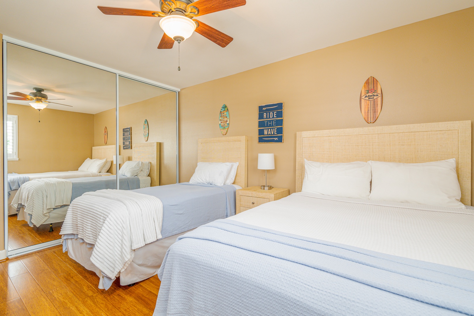 Kapolei Vacation Rentals, Ko Olina Kai 1081C - The upstairs guest bedroom with a ceiling fan and large mirror.