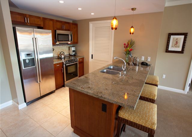 Lahaina Vacation Rentals, Honua Kai Hokulani 214 - This modern kitchen features granite countertops, stainless steel appliances, and a spacious island with seating.