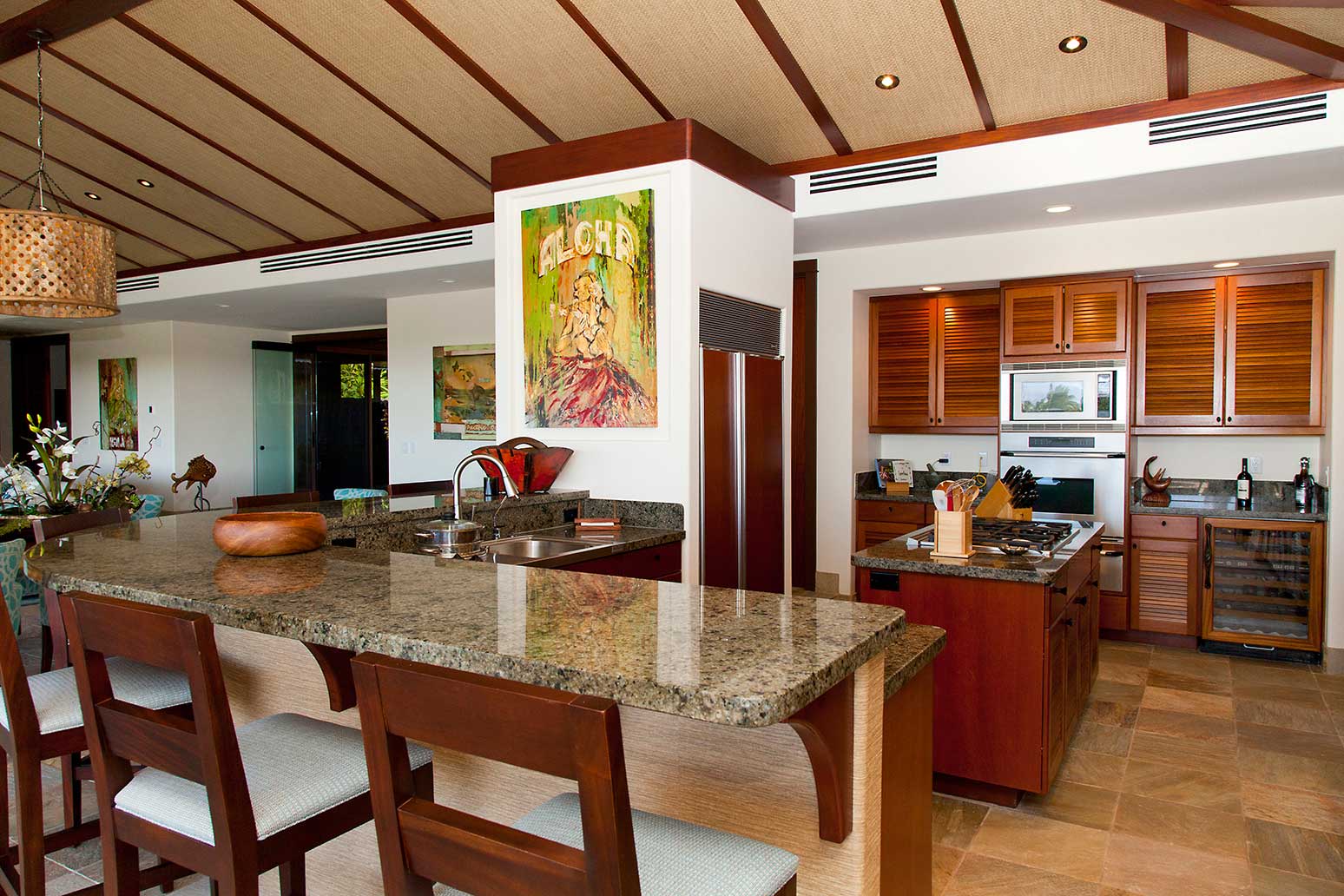 Kamuela Vacation Rentals, 4BD Champion Ridge (CR10) Estate Home at Mauna Lani Resort - Modern gourmet kitchen with top-tier appliances, granite counter tops, and wraparound bar seating.