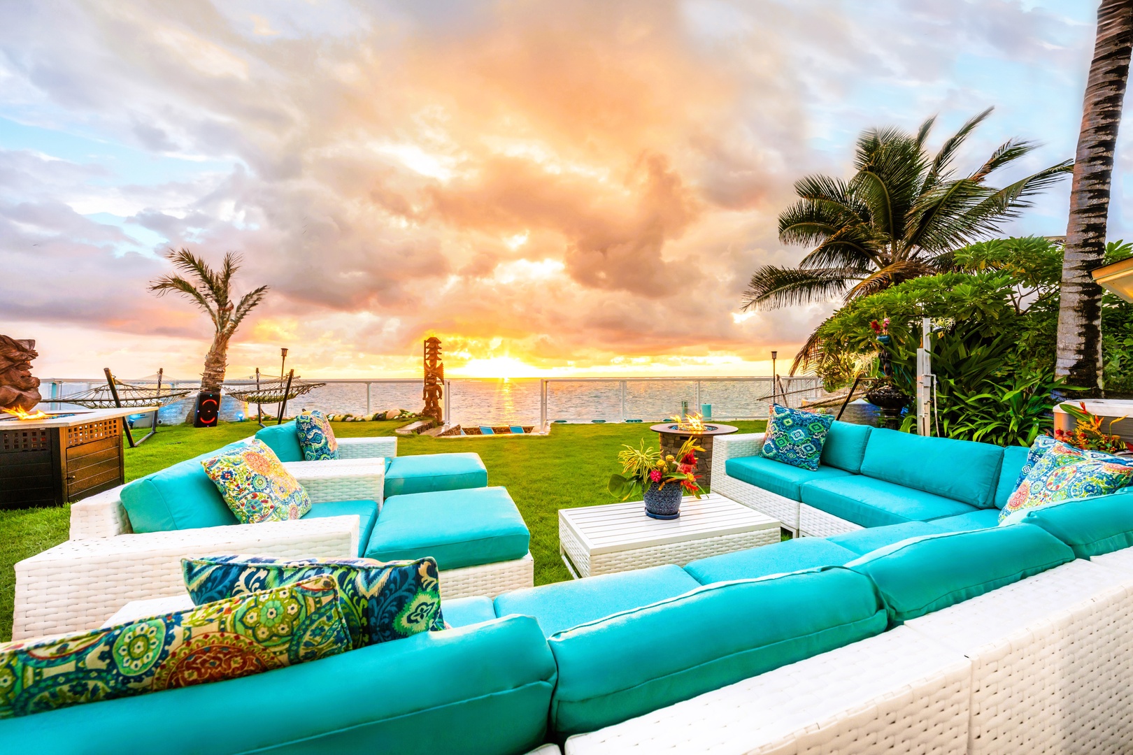 Hauula Vacation Rentals, Private Beach Paradise - Evening pulls everyone to the outdoor sofas as the sky goes gold over the water.
