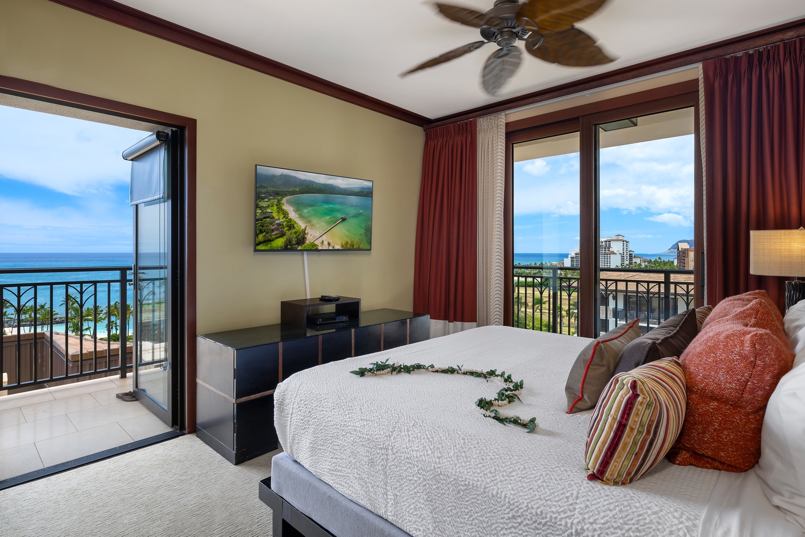 Wake up to endless ocean views from your private lanai in this elegant bedroom with traditional island touches and modern comfort.