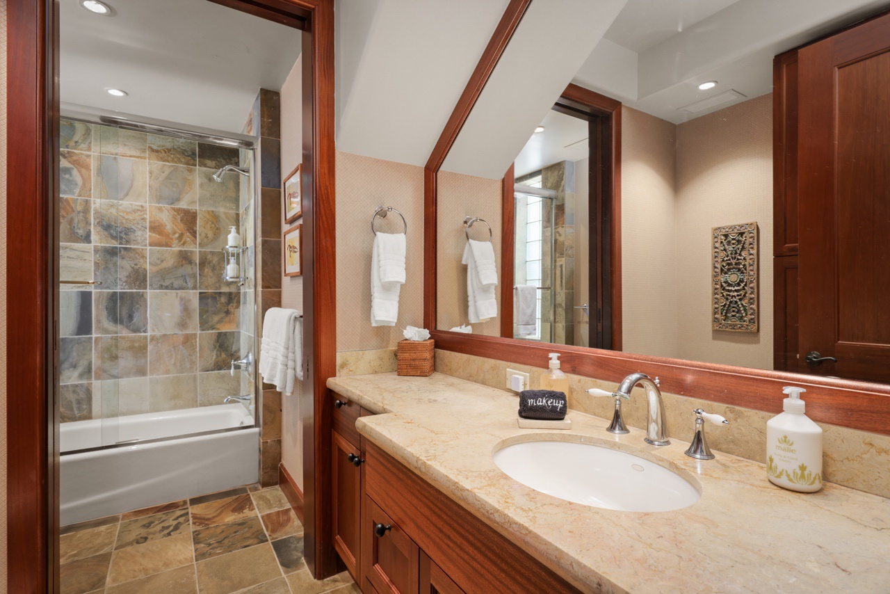 Kailua Kona Vacation Rentals, 3BD Ke Alaula Villa (210A) at Four Seasons Resort at Hualalai - The lower level guest bathroom has a single vanity and shower and tub combo.