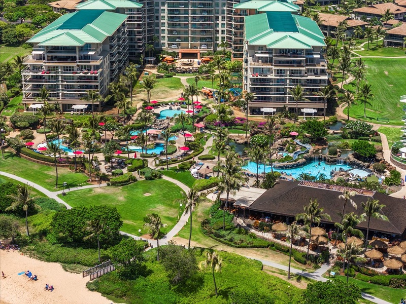 Lahaina Vacation Rentals, Honua Kai Hokulani 214 - A closer aerial view highlighting the resort's pool area, surrounded by lush greenery and luxurious accommodations, offering a perfect retreat.