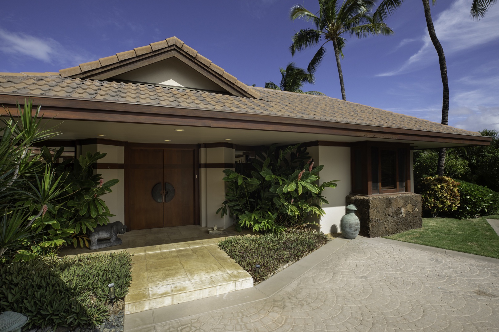 Kamuela Vacation Rentals, Champion Ridge 7 - Tropical villa entrance with lush gardens and swaying palms creating a welcoming Hawaiian paradise arrival experience.