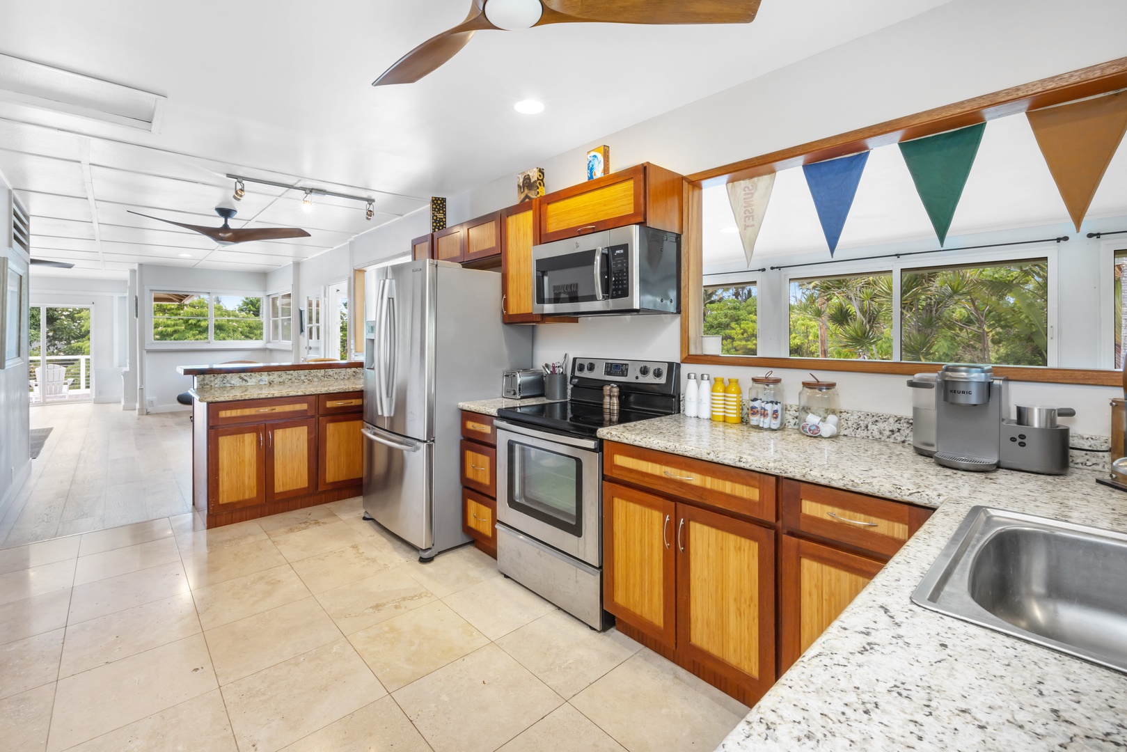 Kahuku Vacation Rentals, Hale Pellicano - The open kitchen boasts stainless steel appliances and ample counter space.