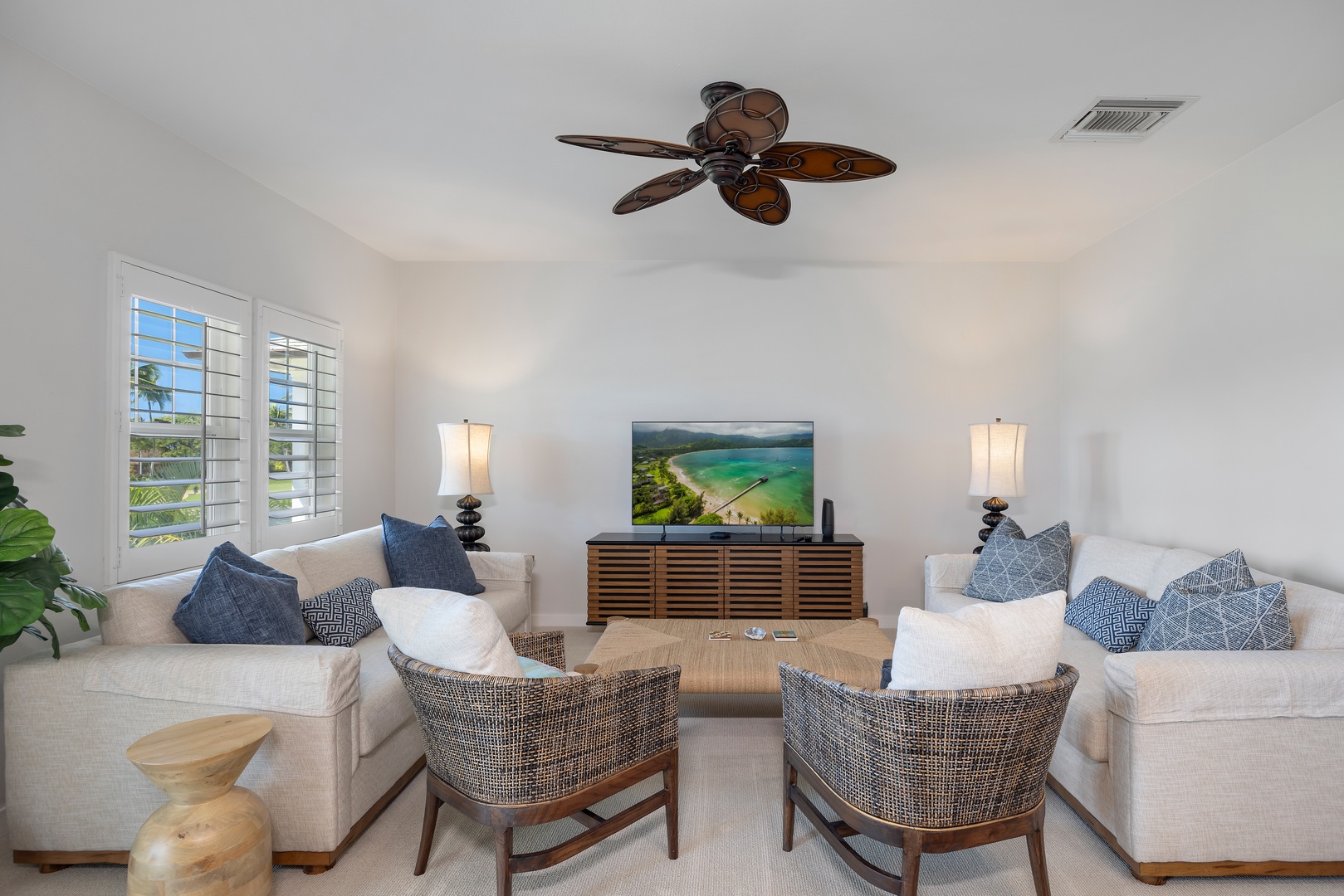 Sink into plush seating while cool ceiling fans create the perfect breeze for your tropical getaway relaxation.