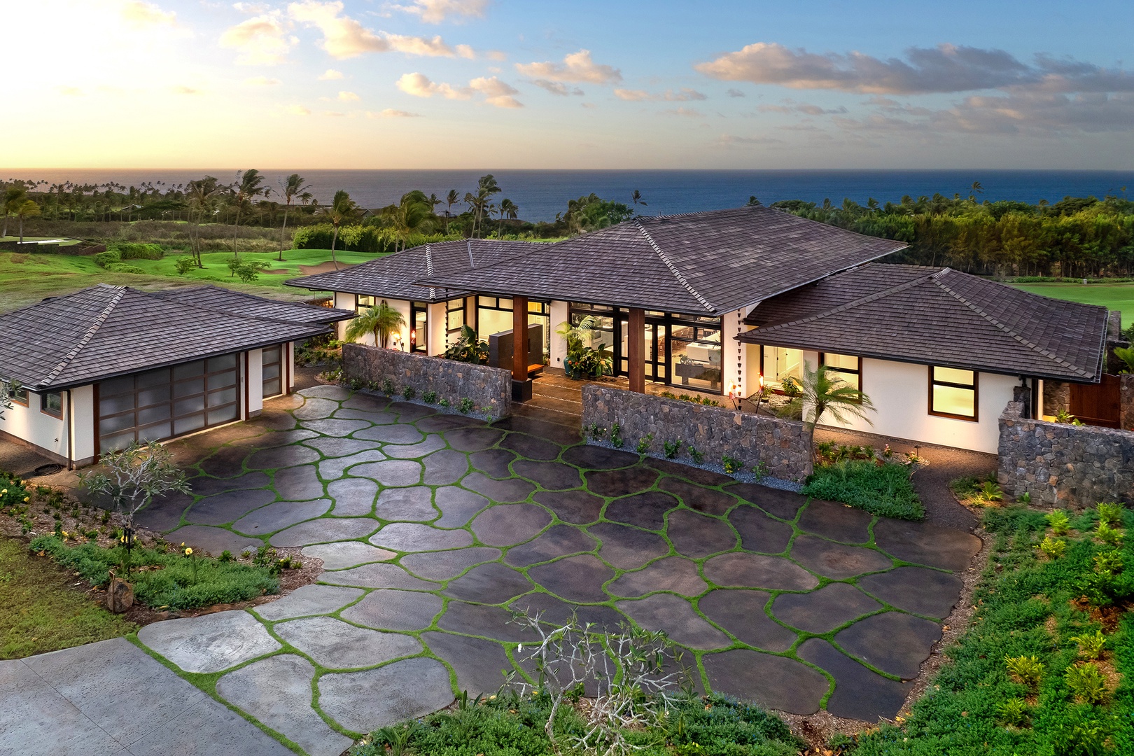 Koloa Vacation Rentals, Ke Kai Nui at Kukuiula - Exterior view of the property, featuring lush landscaping, stone pathways, and spacious outdoor areas.